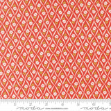 a repeating pattern of red and white flowers on a fabric surface.