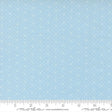 The image is a fabric with a light blue background with small white dots or stars arranged in a pattern.
