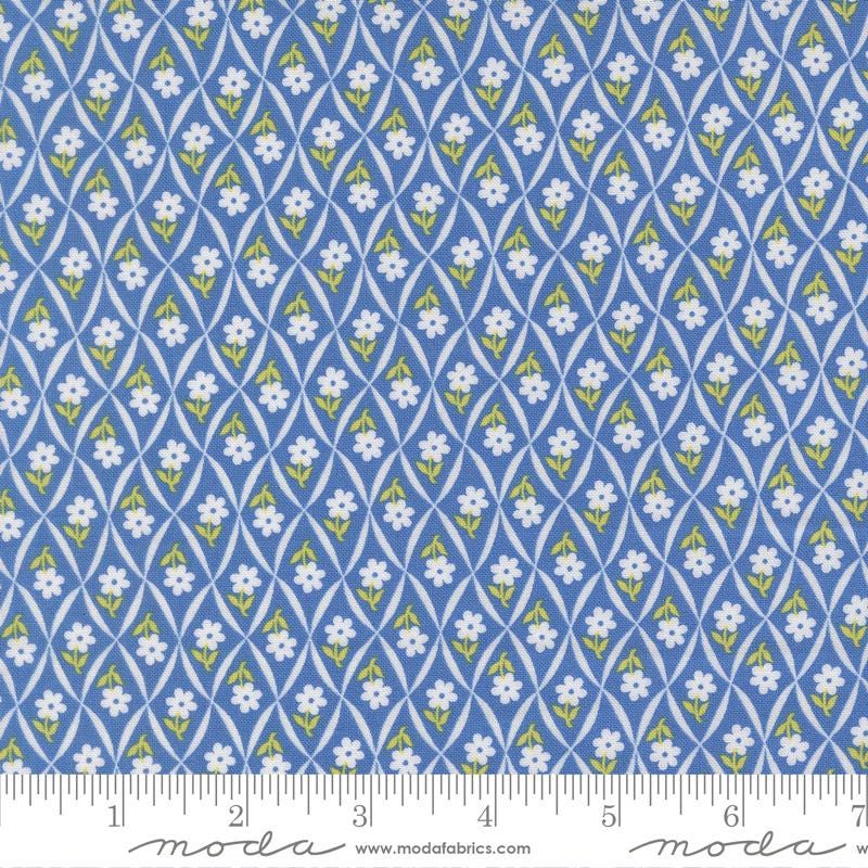 a repeating pattern of blue and yellow flowers on a fabric surface.
