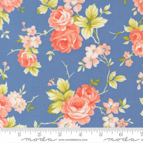 a blue fabric with a floral pattern of pink and white roses and green leaves.