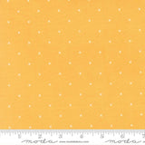 The image is a fabric with a yellow background and white dotted pattern.
