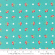 a fabric with a repeating pattern of small white dots and pink flowers on a turquoise background.