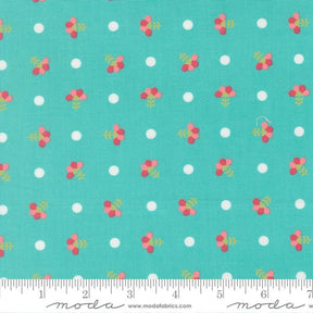 a fabric with a repeating pattern of small white dots and pink flowers on a turquoise background.