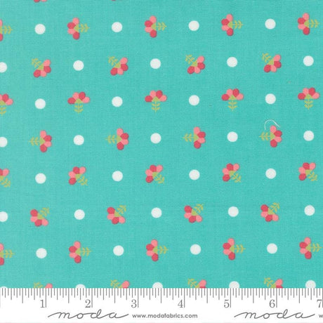 a fabric with a repeating pattern of small white dots and pink flowers on a turquoise background.