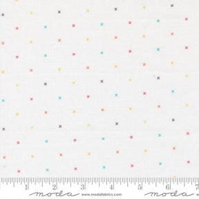 a white background with numerous small, colorful crosses scattered across it. There is a ruler at the bottom of the image, indicating the size of the crosses in millimeters.