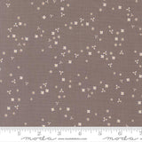 a brown fabric with small white flowers scattered across it.