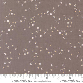a brown fabric with small white flowers scattered across it.