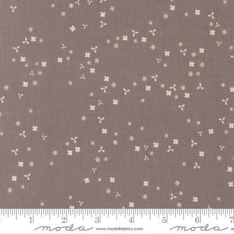 a brown fabric with small white flowers scattered across it.