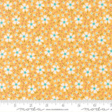 The image is a fabric with a repeating pattern of yellow flowers and leaves on a light orange background.