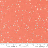 The image is a fabric with a repeating pattern of small white flowers or dots on a bright orange background.
