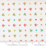 The image is a fabric with a repeating pattern of colorful flowers and polka dots.