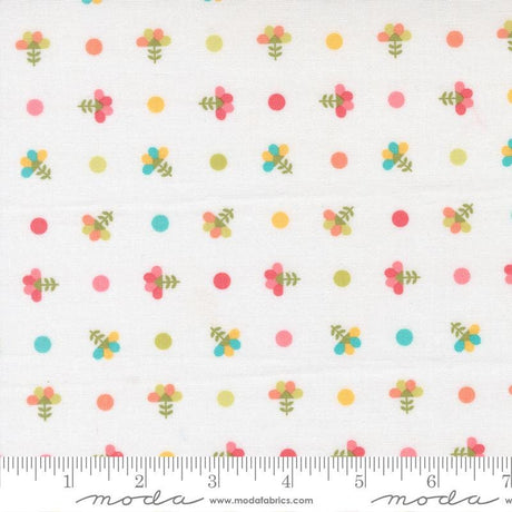 The image is a fabric with a repeating pattern of colorful flowers and polka dots.