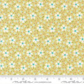 a fabric with a repeating pattern of white flowers with green centers against a yellow background. The fabric appears to be a soft, pastel-colored material, possibly cotton or linen.