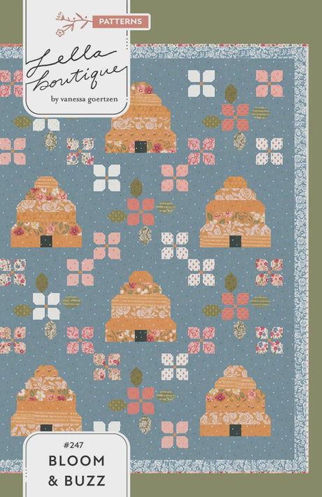 May include: A quilt pattern featuring repeating orange and floral house-like shapes on a blue background. The design includes pink and white floral accents, with the text "#247 Bloom & Buzz" at the bottom. The pattern is by Lella Boutique.