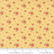 The image is a close-up of a fabric with a repeating pattern of small red flowers on a yellow background.