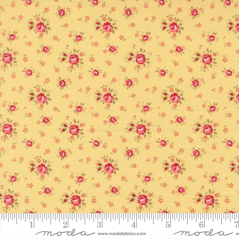 The image is a close-up of a fabric with a repeating pattern of small red flowers on a yellow background.