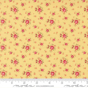 The image is a close-up of a fabric with a repeating pattern of small red flowers on a yellow background.
