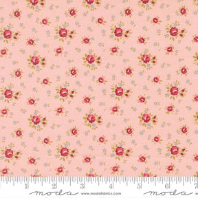 The image is a fabric with a repeating floral pattern in shades of pink and white. The pattern consists of small red flowers and leaves scattered across the fabric, creating a visually appealing and intricate design.