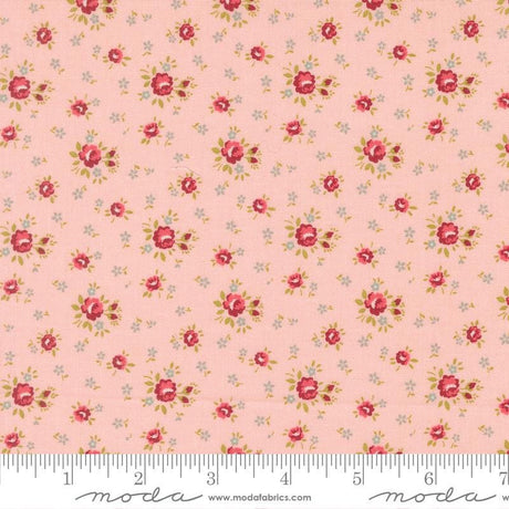 The image is a fabric with a repeating floral pattern in shades of pink and white. The pattern consists of small red flowers and leaves scattered across the fabric, creating a visually appealing and intricate design.