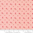 a repeating pattern of pink flowers and leaves on a fabric surface.