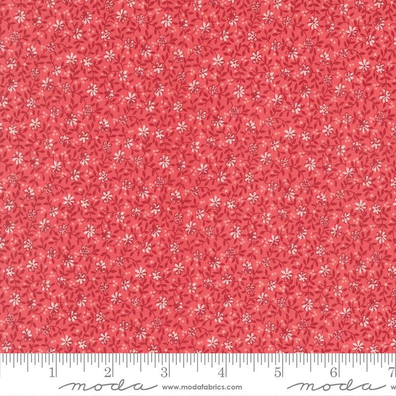 The image is a close-up of a fabric with a red floral pattern.