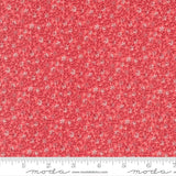 The image is a close-up of a fabric with a red floral pattern.