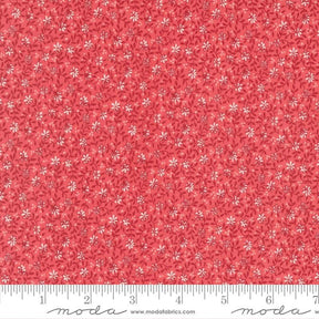 The image is a close-up of a fabric with a red floral pattern.