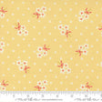 The image is a fabric with a yellow background and white polka dots, featuring small white flowers with pink bows.