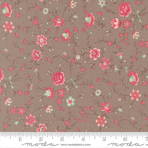 The image is a fabric with a floral pattern, featuring various pink and green flowers and leaves. The fabric appears to be a dark brown color, and there is a ruler at the bottom of the image for scale.
