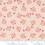 The image is a fabric with a repeating pattern of pink flowers and birds on a light pink background.