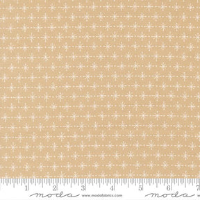 a fabric with a repeating pattern of white snowflakes on a beige background.