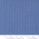 The image is a close-up of a fabric with a blue background and white dots or stars arranged in a pattern.