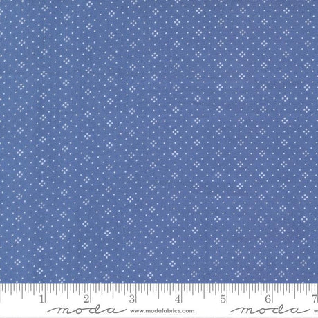 The image is a close-up of a fabric with a blue background and white dots or stars arranged in a pattern.