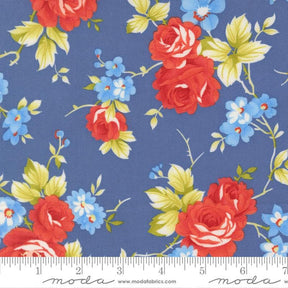 a fabric with a floral pattern of red roses and blue flowers against a blue background.