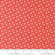 The image is a red fabric with a repeating pattern of white flowers or leaves. The pattern is evenly spaced and covers the entire fabric.