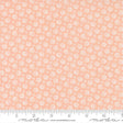 The image is a fabric with a repeating pattern of small white flowers or circles on a peach-colored background.