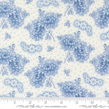 a repeating pattern of blue flowers and leaves on a light background.