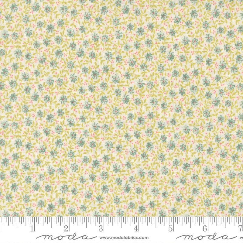 The image is a fabric with a floral pattern in shades of yellow and green.