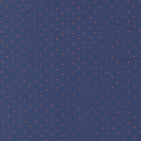a close-up view of a fabric with a pattern of small red dots against a navy blue background.