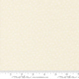 The image is a fabric with a repeating pattern of small white flowers or dots. The fabric appears to be light beige in color.