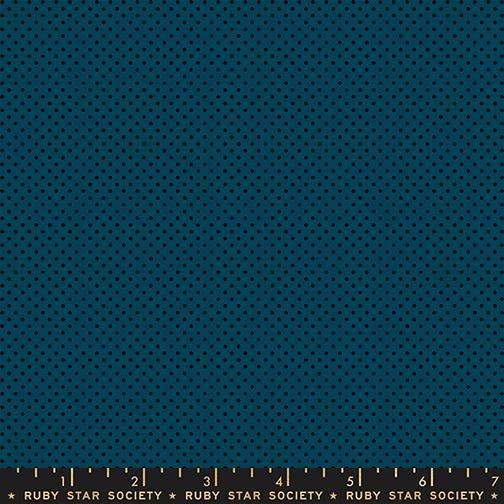 The image is a close-up of a dark blue fabric with a pattern of small black dots, resembling a polka dot design.