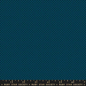 The image is a close-up of a dark blue fabric with a pattern of small black dots, resembling a polka dot design.