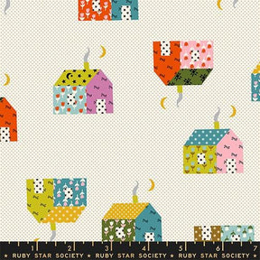 a repeating pattern of colorful houses and crescent moons on a white background.