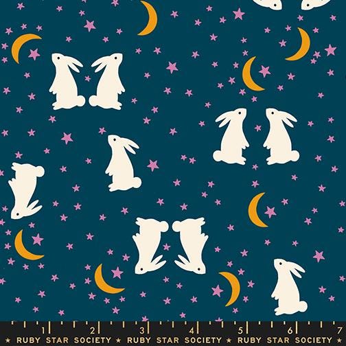 The image is a pattern featuring white rabbits against a dark blue background with stars and crescent moons.
