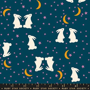 The image is a pattern featuring white rabbits against a dark blue background with stars and crescent moons.