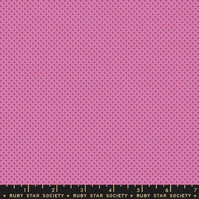 The image is a large pink fabric with a polka dot pattern.
