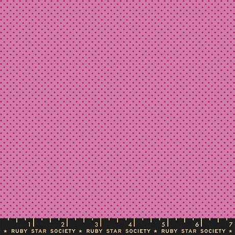 The image is a large pink fabric with a polka dot pattern.