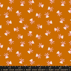 a repeating pattern of pink flowers against a brown background.