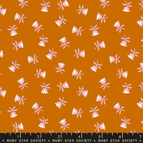 a repeating pattern of pink flowers against a brown background.