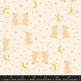 a pattern of pink and yellow rabbits and crescent moons against a starry night sky background.